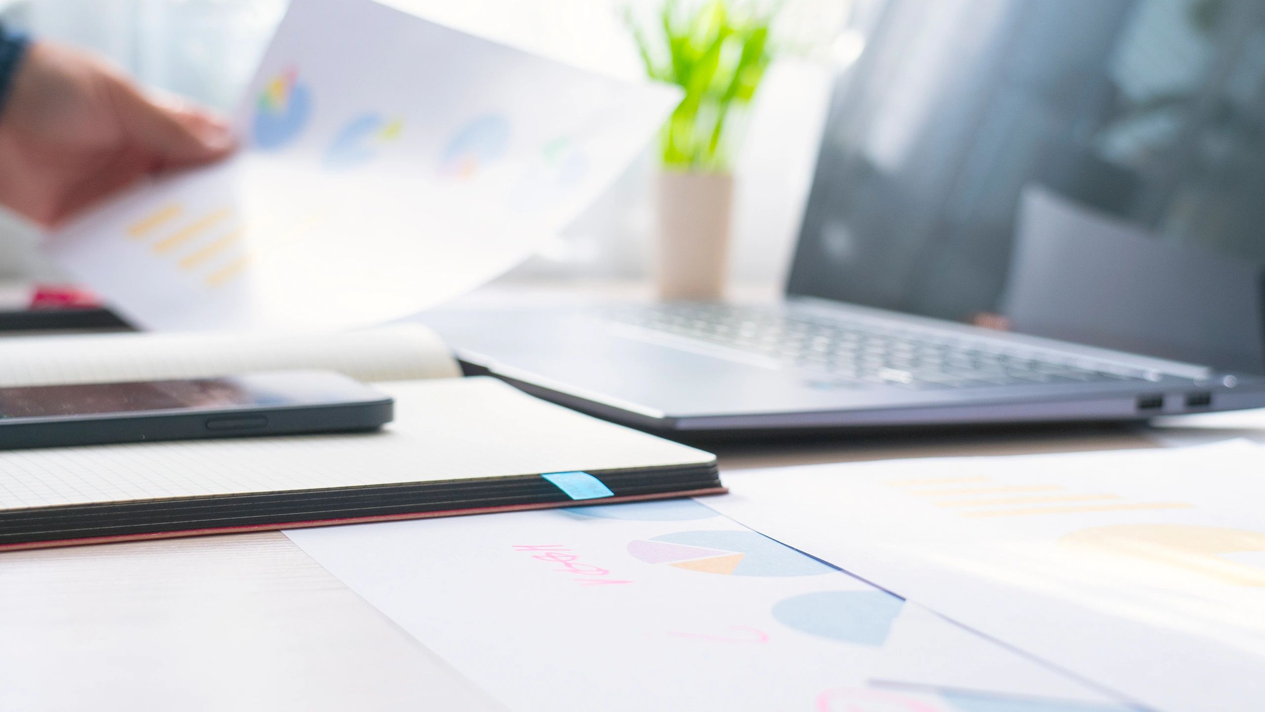 Minimalist desk with laptop and documents, representing organized financial strategy work